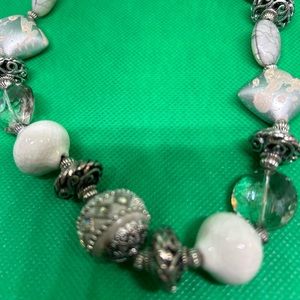 Stretchy necklace with unusual white beads and silver tone